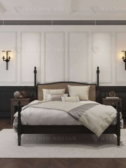 The main view of the classic bedroom, showing the elegant symmetry of the design with matching bedside tables and a gallery wall of black-and-white prints.