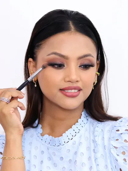 "I love the confidence that makeup gives me." This shot captures the process of creating a beautiful smokey eye look.