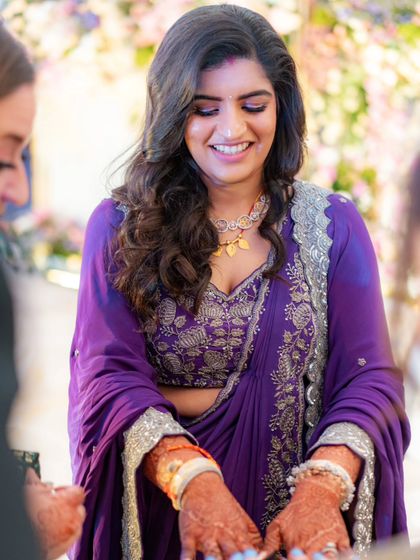 Another beautiful, happy shot of the bride at her reception. The intricate silver embroidery on her blouse and the elegant drape of her gown are highlighted in this candid moment.