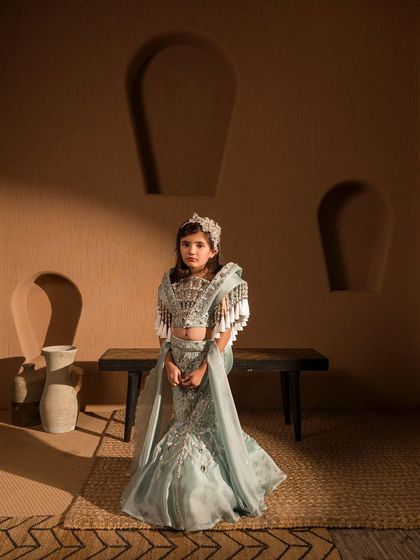 This powder blue mermaid lehenga has a unique, fan like structured blouse with tassels, creating a true princess look.