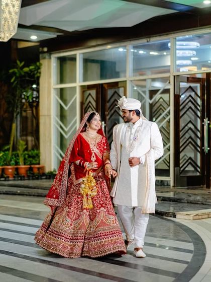 The grand entrance as husband and wife. This shot captures the couple's coordinated wedding attire and the joy of their first steps together.