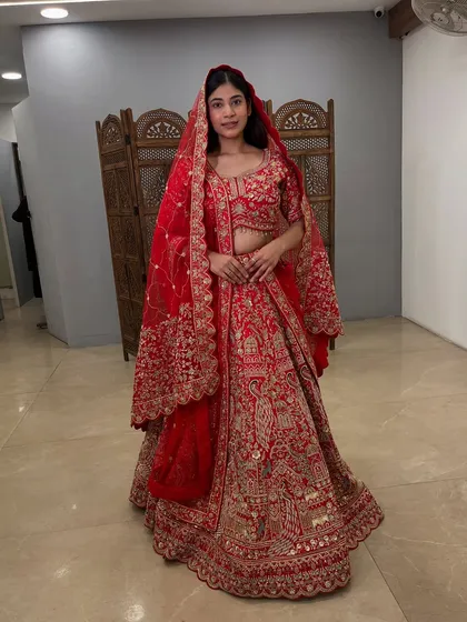 Feel like a queen in this stunning red bridal lehenga, available to rent at a fraction of its original price.