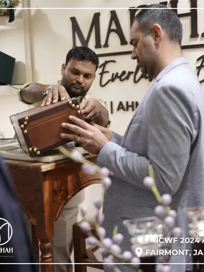 A client examining the fine craftsmanship of one of our wooden keepsake boxes at ICWF 2024. I take pride in the quality and detail of every piece.
