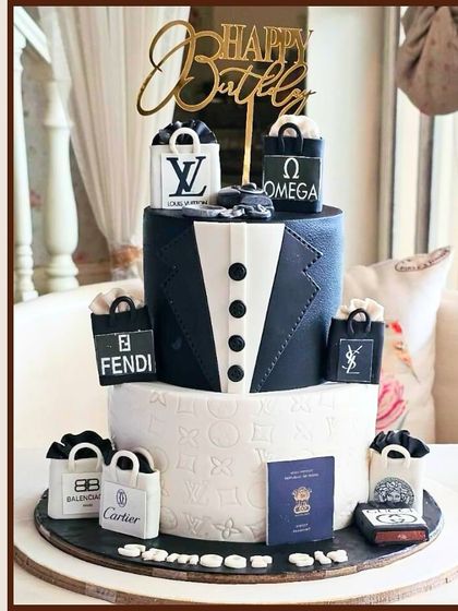 A luxurious two-tier birthday cake for a fashion lover, adorned with edible shopping bags from brands like Louis Vuitton, Fendi, and Cartier.