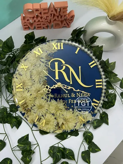 This top-down view provides a clear look at the entire layout, from the floral arc to the pearl-studded border and custom text.