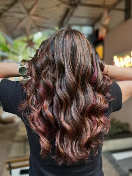 The colors in this balayage are just GIVING. The mix of brown and magenta is unique and totally stunning.