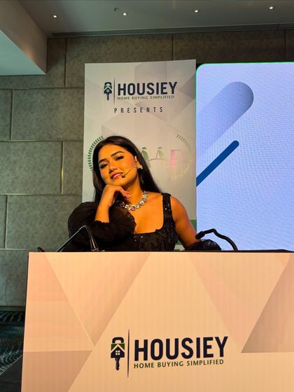 A candid moment behind the podium. Even when I'm not speaking, I'm fully engaged with the event's flow.