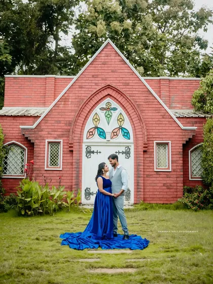 We find magic in unique locations, like this charming chapel-style building. The vibrant blue of her gown creates a beautiful contrast, making for a truly fairytale-like pre-wedding portrait.