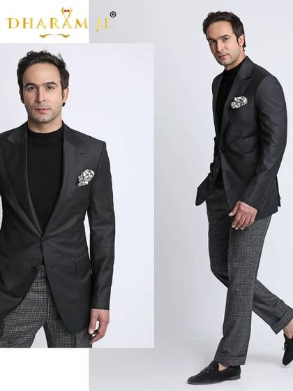 A modern take on a formal suit. A black blazer paired with grey patterned trousers and loafers for a smart, semi-formal look.
