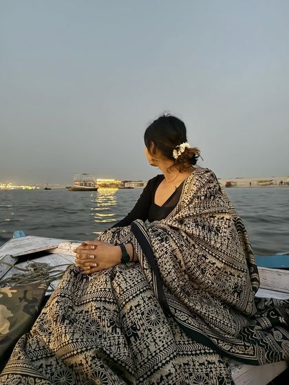 A moment of peace and reflection. The timeless elegance of a saree against the backdrop of the ancient city of Varanasi is a truly special experience.