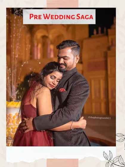 A romantic embrace captured during an evening pre-wedding shoot. The couple is styled in our coordinated rental outfits, with her in a deep red gown and him in a textured bandhgala jacket.