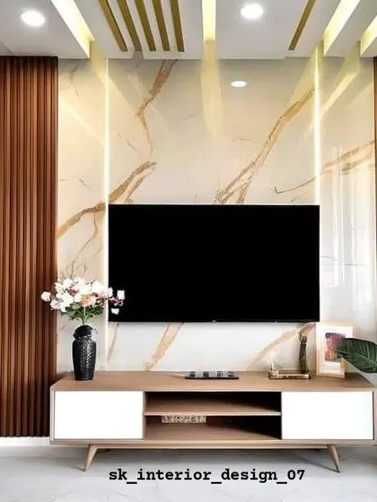 A bold TV wall design using a large marble-finish panel framed by dark wood slats. The simple, low console keeps the focus on the dramatic backdrop.