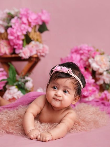 This curious baby is enjoying some tummy time on a soft pink rug. I capture different milestones, including when they can start lifting their head.