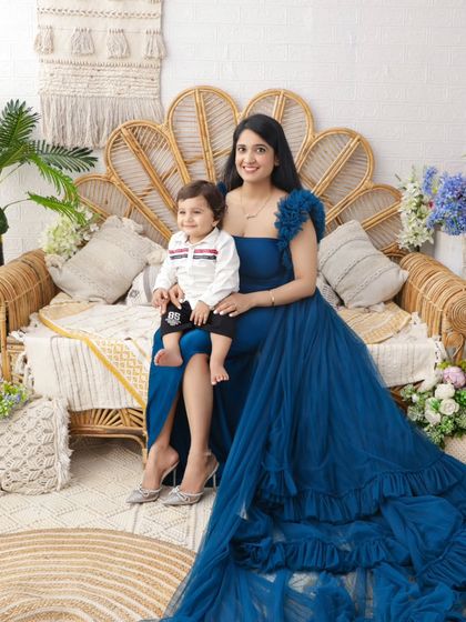 A stunning portrait of a mother and son during her maternity session. The flowing blue gown adds a touch of royalty and elegance.