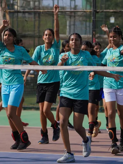 The team moves in sync during warm-up drills. This not only prepares them physically but also builds team cohesion and focus before practice begins.