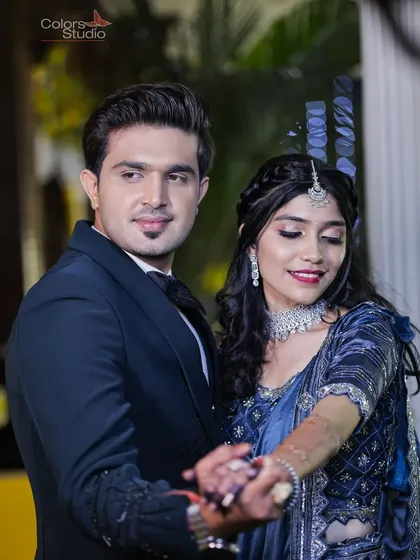 A classic dance pose from the couple's Sangeet night, showcasing their elegant blue outfits.