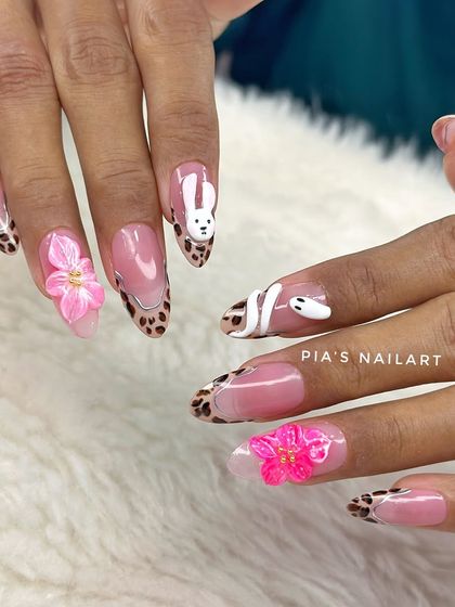 Keeping up with the trends. This fun set combines a leopard print French tip with 3D sculpted elements like a bunny, a snake, and vibrant pink flowers.