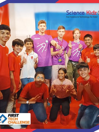 A moment of camaraderie at the FIRST Tech Challenge, as our team interacts with a team from another country, embodying the spirit of Gracious Professionalism.