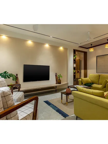 This shot showcases the entire living room layout, designed for an elderly couple and their family. The space is warm, welcoming, and rooted in comfort, with easy-to-navigate pathways.