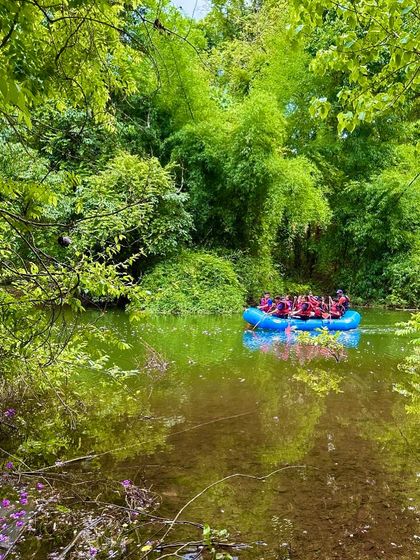A team of young adventurers paddles through a narrow channel flanked by dense bamboo groves at our Shivpura summer camp.
