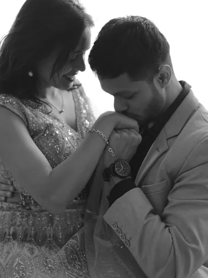 An intimate and romantic gesture captured in a timeless black and white photo.