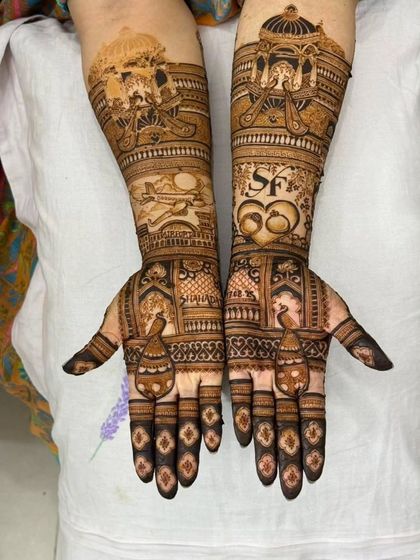 The full view of the engagement mehandi, showing how we incorporated the couple's story across both arms with custom motifs.