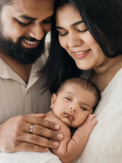 The peacefulness of a sleeping newborn held lovingly in their parents' arms is a moment to treasure.