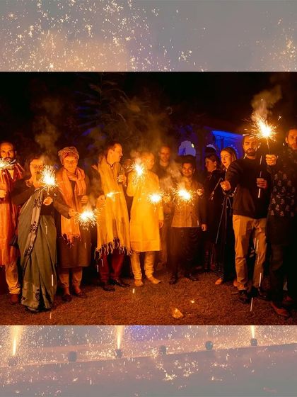 A group of friends and family celebrating Diwali together with sparklers.