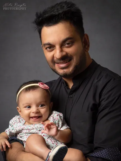 A father's first love. This portrait of a dad and his baby daughter captures the special bond they share with a simple, timeless look.