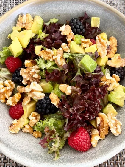 A simple salad can be a feast for the senses. This one combines fresh greens with avocado, walnuts, and mixed berries. The walnuts provide a satisfying crunch and a dose of omega-3s, while the berries add a touch of sweetness and antioxidants.