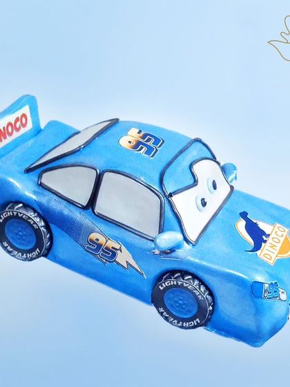 A blue Lightning McQueen cake, ready to race. This cool design is a fun twist on the classic red car, perfect for a "Cars" movie fan.