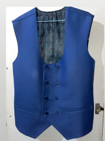 The details make the difference. This is a double breasted waistcoat I stitched, featuring a unique U-neck design and a beautiful patterned inner lining. I can create waistcoats as part of a three piece suit or as a separate piece to elevate your formal look.