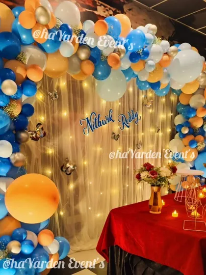 A close-up of a party setup with a fairy light curtain, which adds a warm and magical glow.