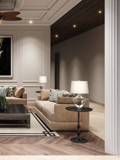 A detail shot of the family lounge, focusing on the soft lighting from the table lamps and the texture of the fluted column, which adds a classical touch.