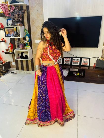 A full-length standing shot of the multi-color patchwork Garba lehenga, showing its beautiful drape and flare.