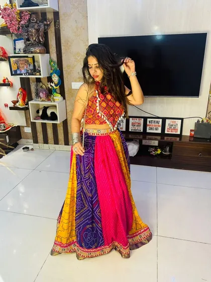 A full-length standing shot of the multi-color patchwork Garba lehenga, showing its beautiful drape and flare.