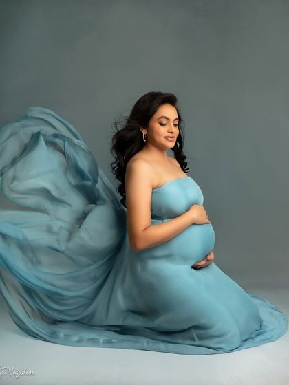 A kneeling pose in a flowing blue gown creates such a graceful and artistic silhouette. It's a beautiful way to show off the dress and your bump.