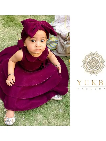 A closer look at the details of my custom velvet party dress. Made from the softest material for delicate skin, this design features a full, tiered skirt for a touch of drama and a sweet Peter Pan collar. The oversized bow headband is the perfect finishing touch for a memorable look.