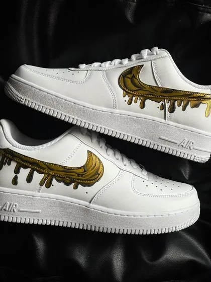 A pair shot of the liquid gold drip custom sneakers.