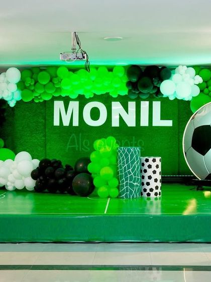 A winning goal for a football fan's birthday. I transformed the stage into a mini football field for Monil, complete with a goal, a giant 3D football, and a balloon arch in team colors.