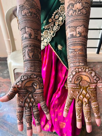 Another view of Priyanka's bridal mehendi, showcasing the symmetrical peacock designs on both palms.