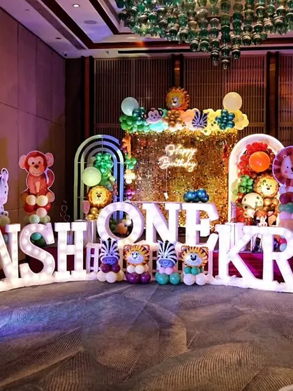 The grand decor for a first birthday party, featuring large, illuminated letters spelling out the children's names. We are experienced in capturing large-scale, elaborately themed events for kids.
