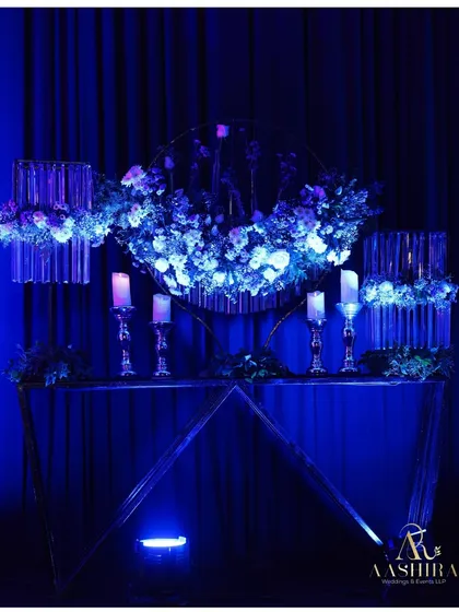 A modern art installation where florals were placed in hanging test tubes and illuminated by blue light, creating a sense of floral poetry.