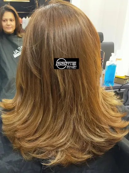 The same beautiful layered haircut from a slightly different angle, showing how the layers fall perfectly to frame the face and add volume.
