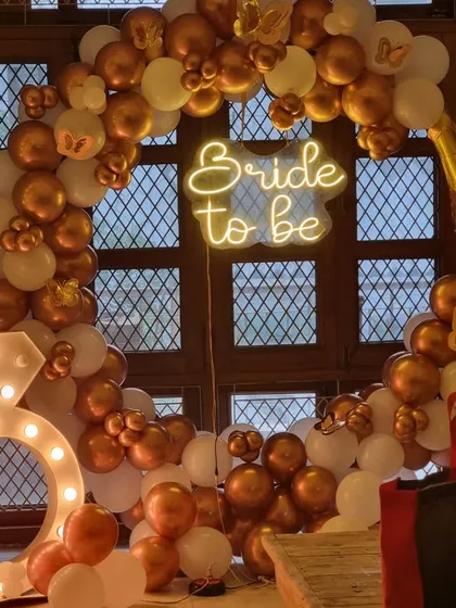 A closer look at our popular indoor "Bride to be" setup, showing the champagne bottle balloon and the glowing diamond ring marquee light.