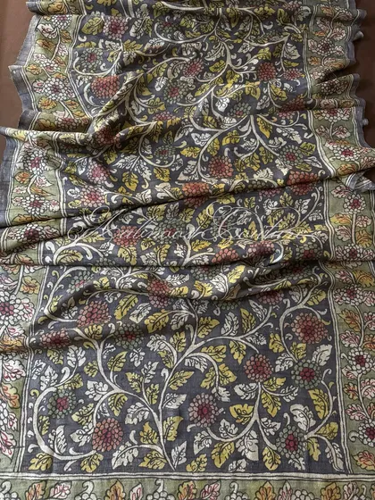 This is a full view of our authentic Srikalahasti Kalamkari art on a charcoal grey silk drape. Every intricate floral vine is hand-painted using traditional techniques and natural vegetable dyes, making each dupatta a unique piece of art.