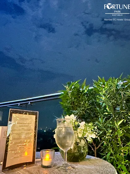 A simple, elegant table setting for one at Nakshatra, perfect for a quiet evening enjoying a drink and the serene night sky.