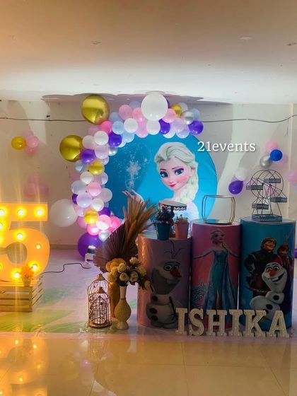 Another angle of the Frozen party setup, showing the character pedestals and marquee number '5'.