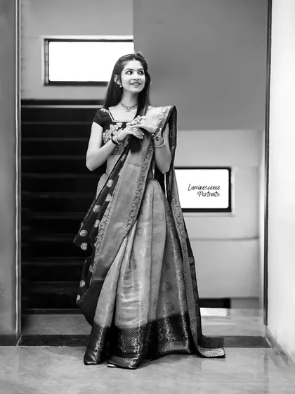 A timeless black and white version of the half-saree portrait, emphasizing the rich textures and elegant drape of the traditional attire.