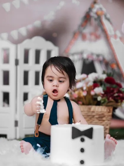 Dressed up and ready for his first taste of cake. This little gentleman is looking sharp for his cake smash session, a fun and memorable way to celebrate turning one.